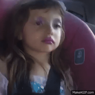 a gif of a popular meme. it shows a young girl, maybe 6 years old, with very messy hot pink lip stick, and completely disheveled pink glitter eyeshadow smeared all around her eyes. She's looking around as if sad or unimpressed until she catches eyes with the camera that's slowly zooming in on her. she makes a very cheesy, self satisfied smirk.